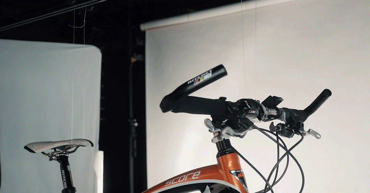 Product photography of bicycle suspended on strings