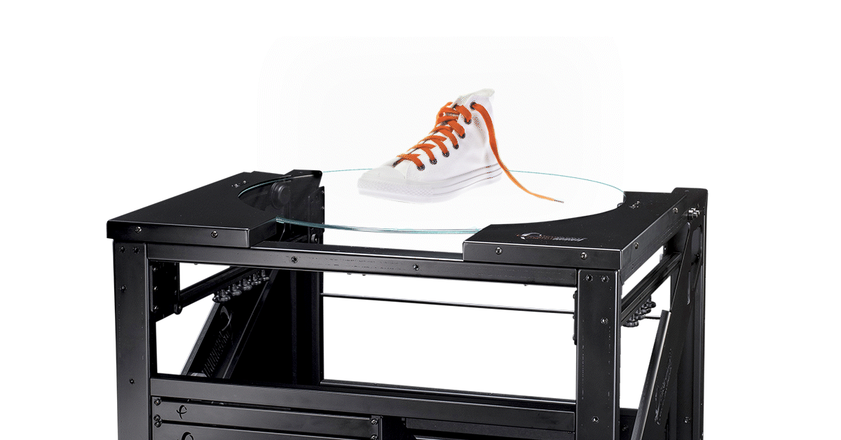 White high-top sneaker with orange laces spinning on turntable.