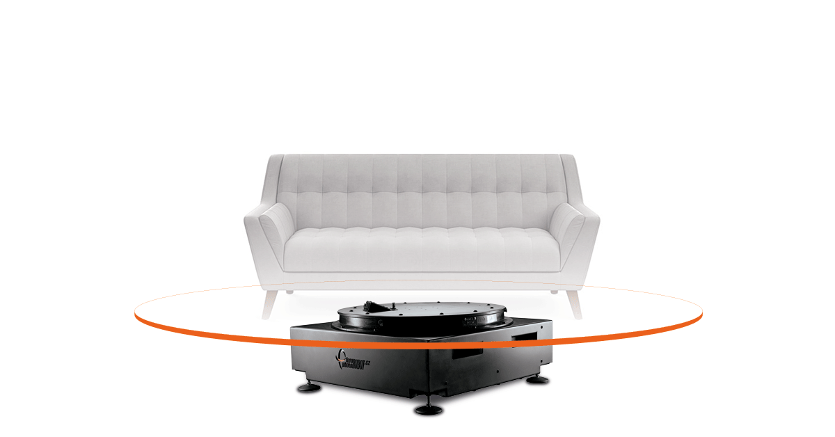 White couch rotating on larger photography turntable.