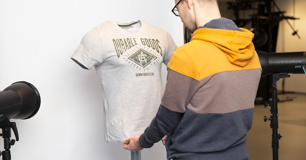 Ensure the hem of the shirt is even and pulled tightly down to remove any creases or wrinkles in the material.