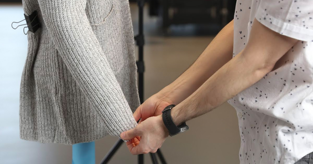 Photo of pulling sleeves down mannequin arms.