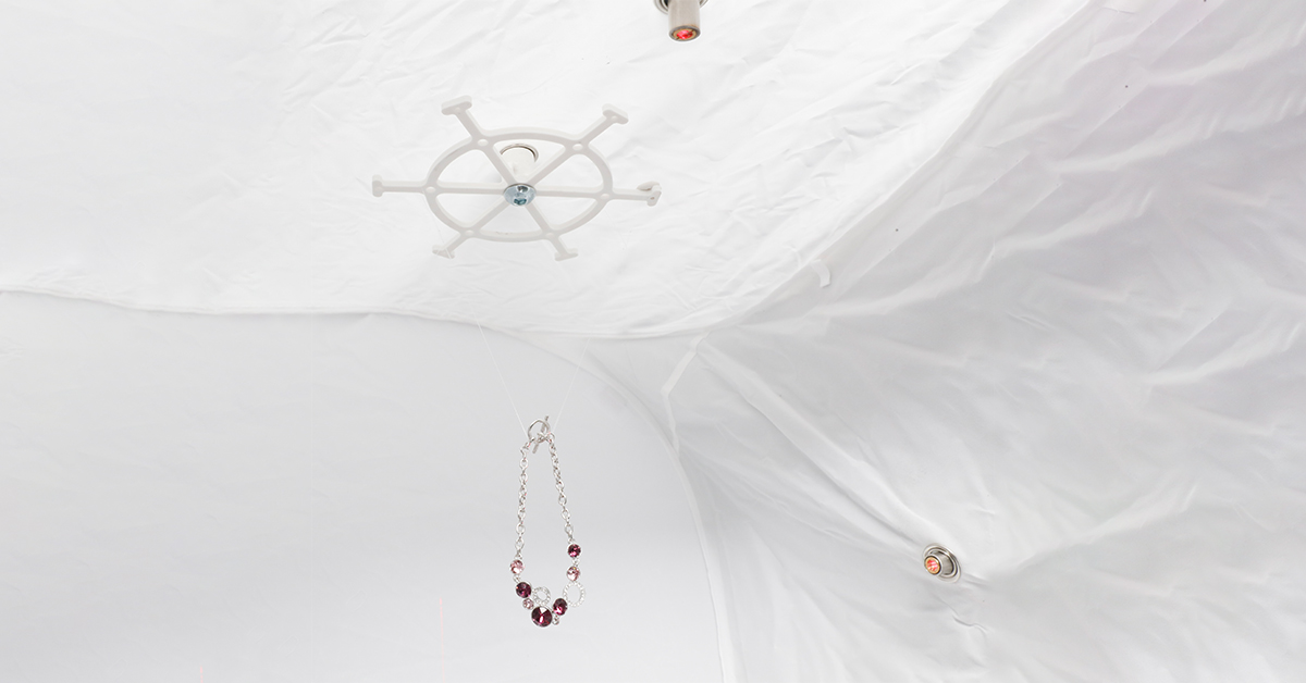 Jewelry hanging inside light tent - photoshoot preparation