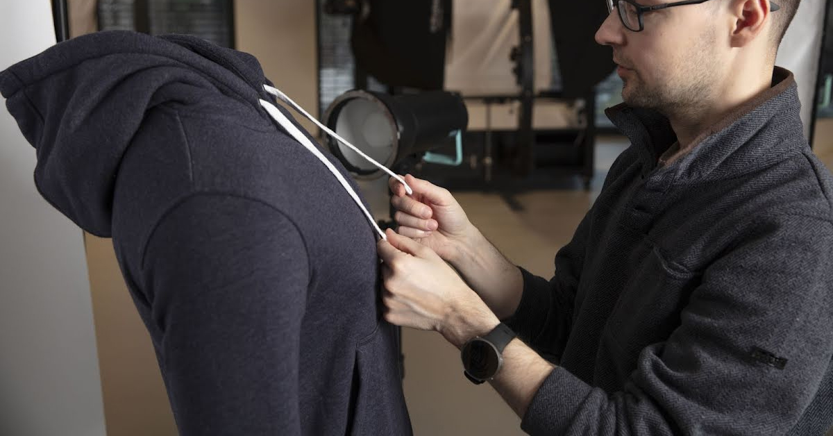 Photographer making drawstrings even.