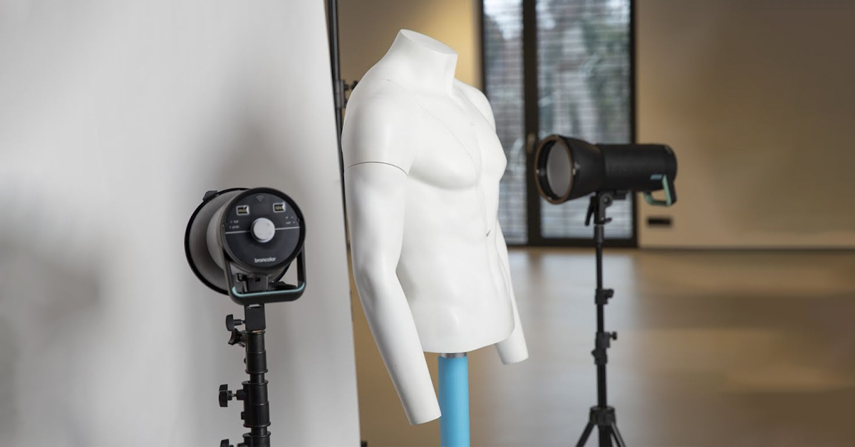 Unclothed male mannequin with lighting setup.