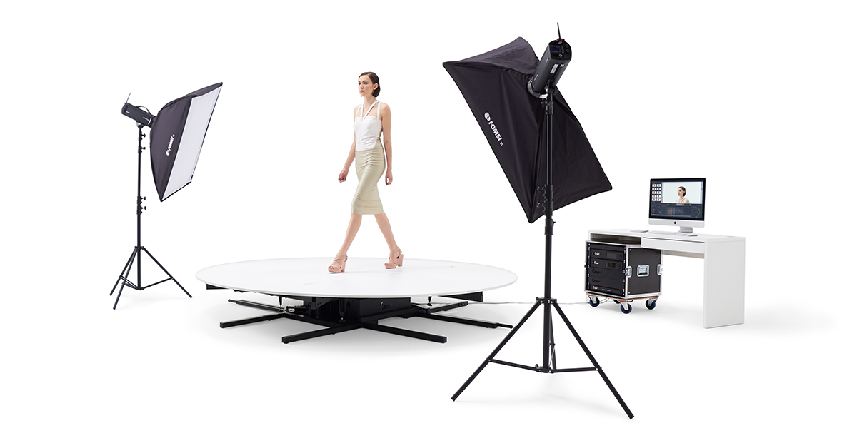 Studio setup with catwalk, model, lights, and computer.