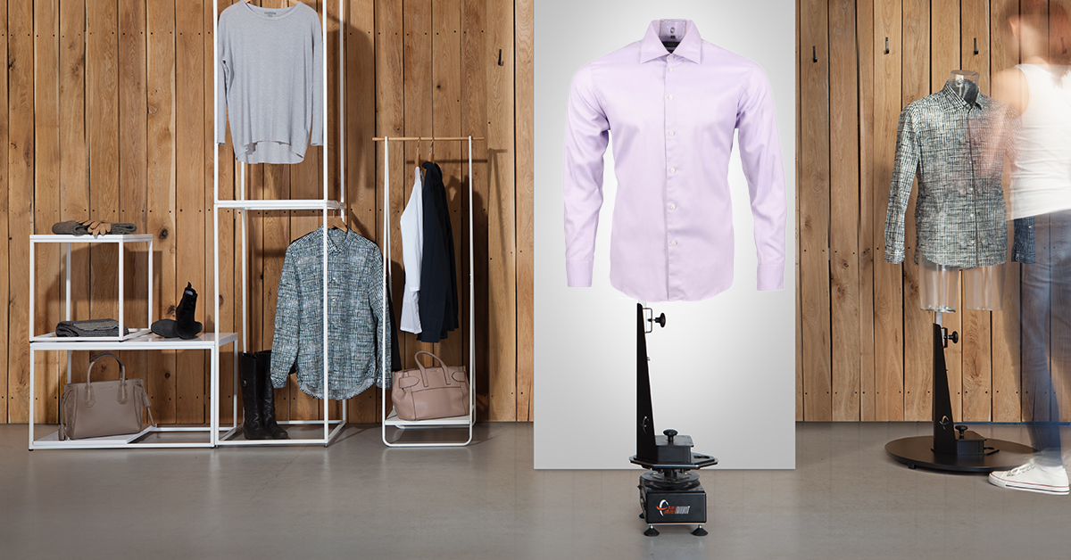 Mannequin installation with shirt and apparel in background.