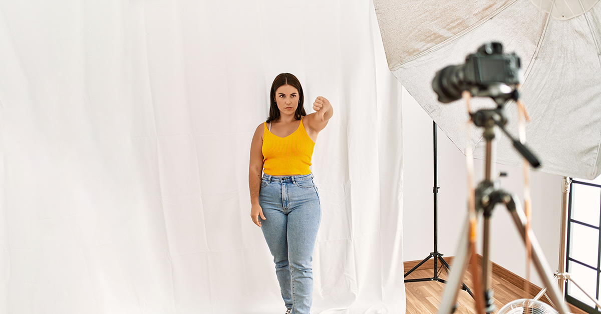 Model in studio giving the thumbs down.