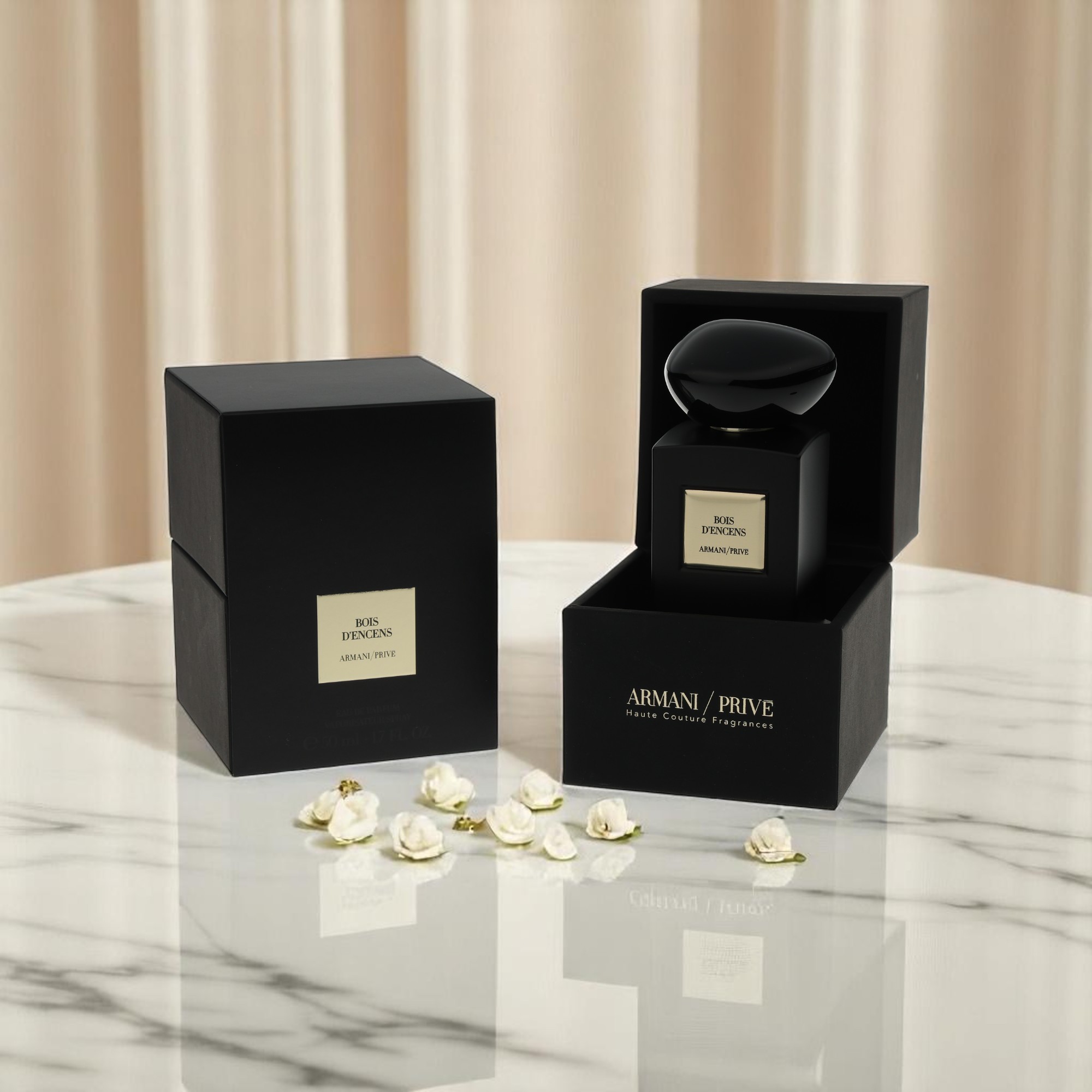 A packshot of Armani / Prive perfume and its package appears on a white marble table with flowers.